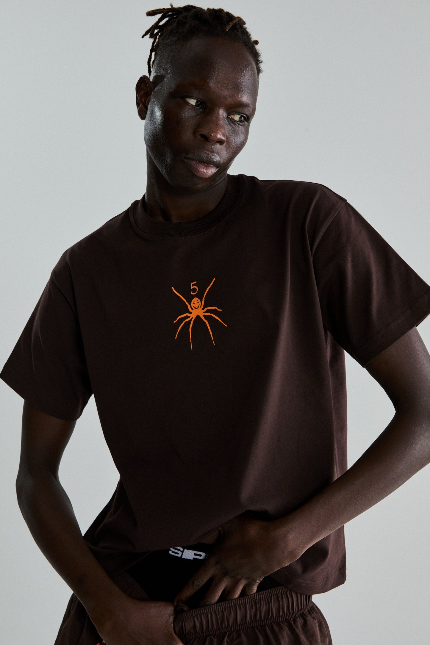 BROWN TM TEE ON MODEL
