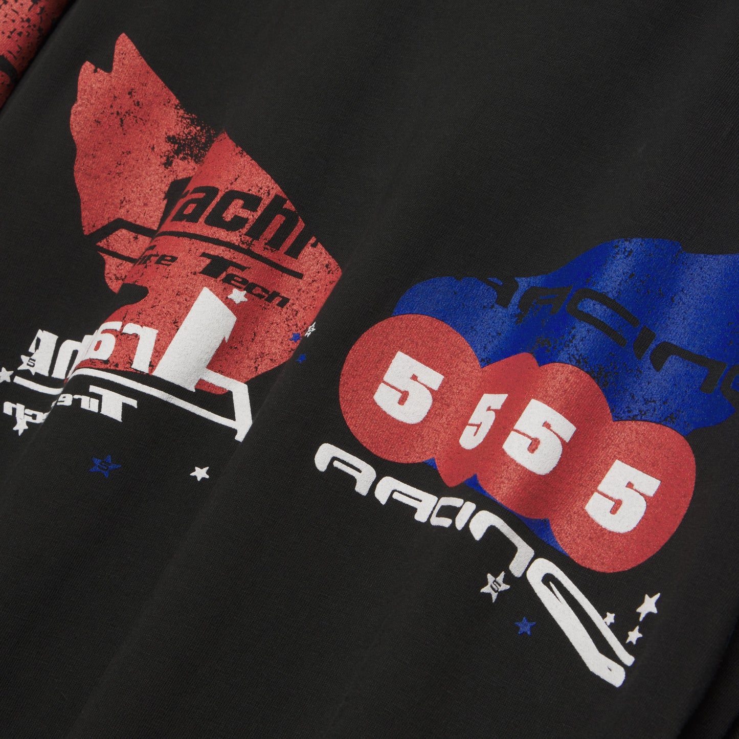 Black 100% cotton long sleeve tee with red, white, and blue graphic print on front and sleeves.