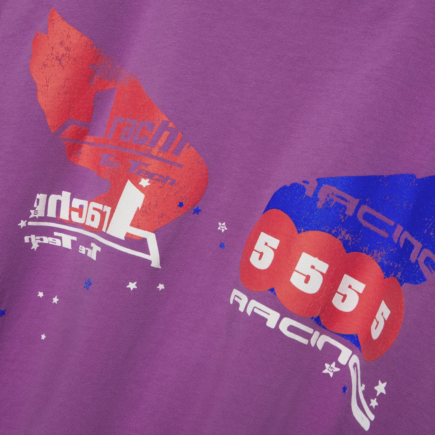Purple 100% cotton long sleeve tee with red and blue graphic print, "RACING" text, and stars.