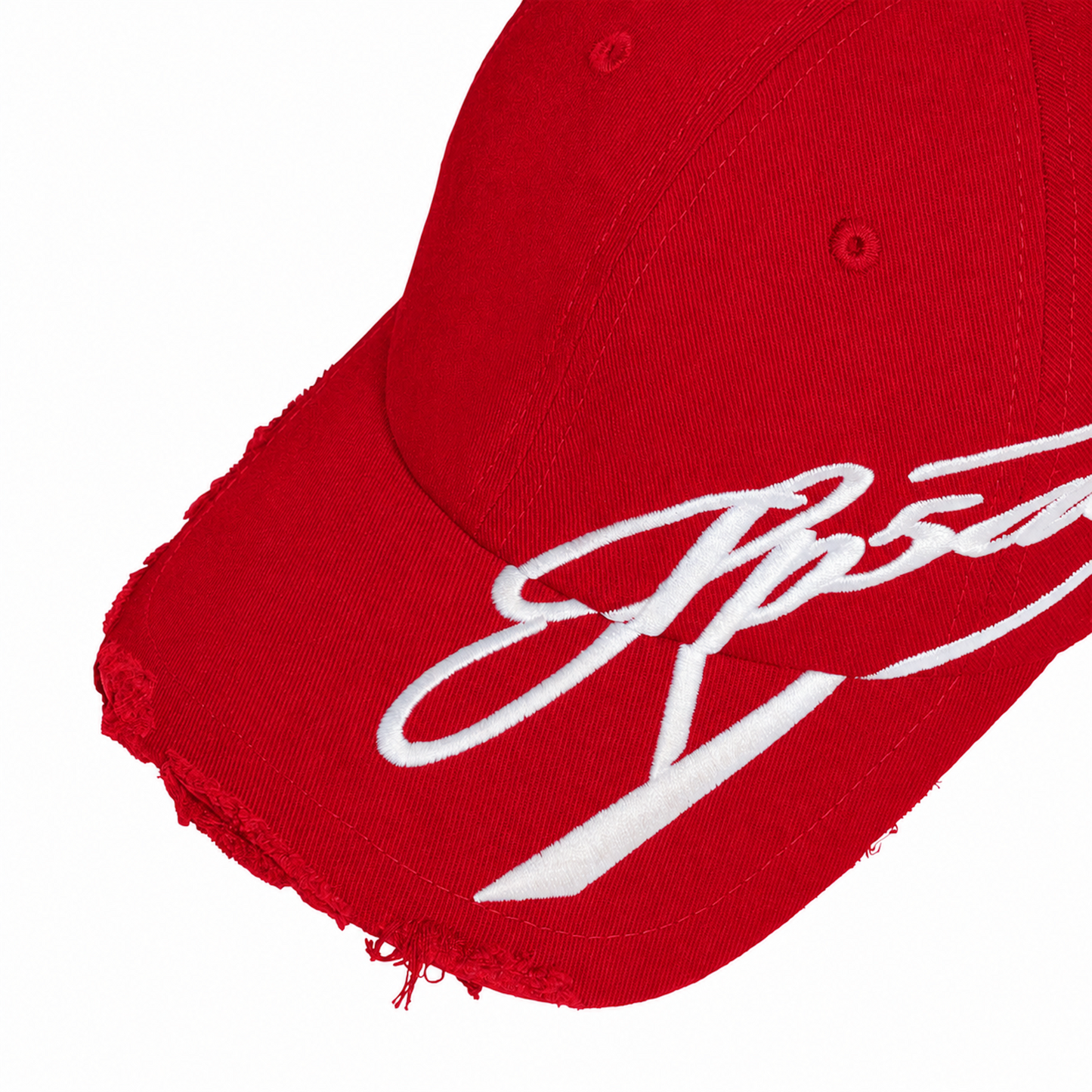 Bright red baseball cap with distressed brim edges and white cursive graphic embroidery extending from the front to the side.