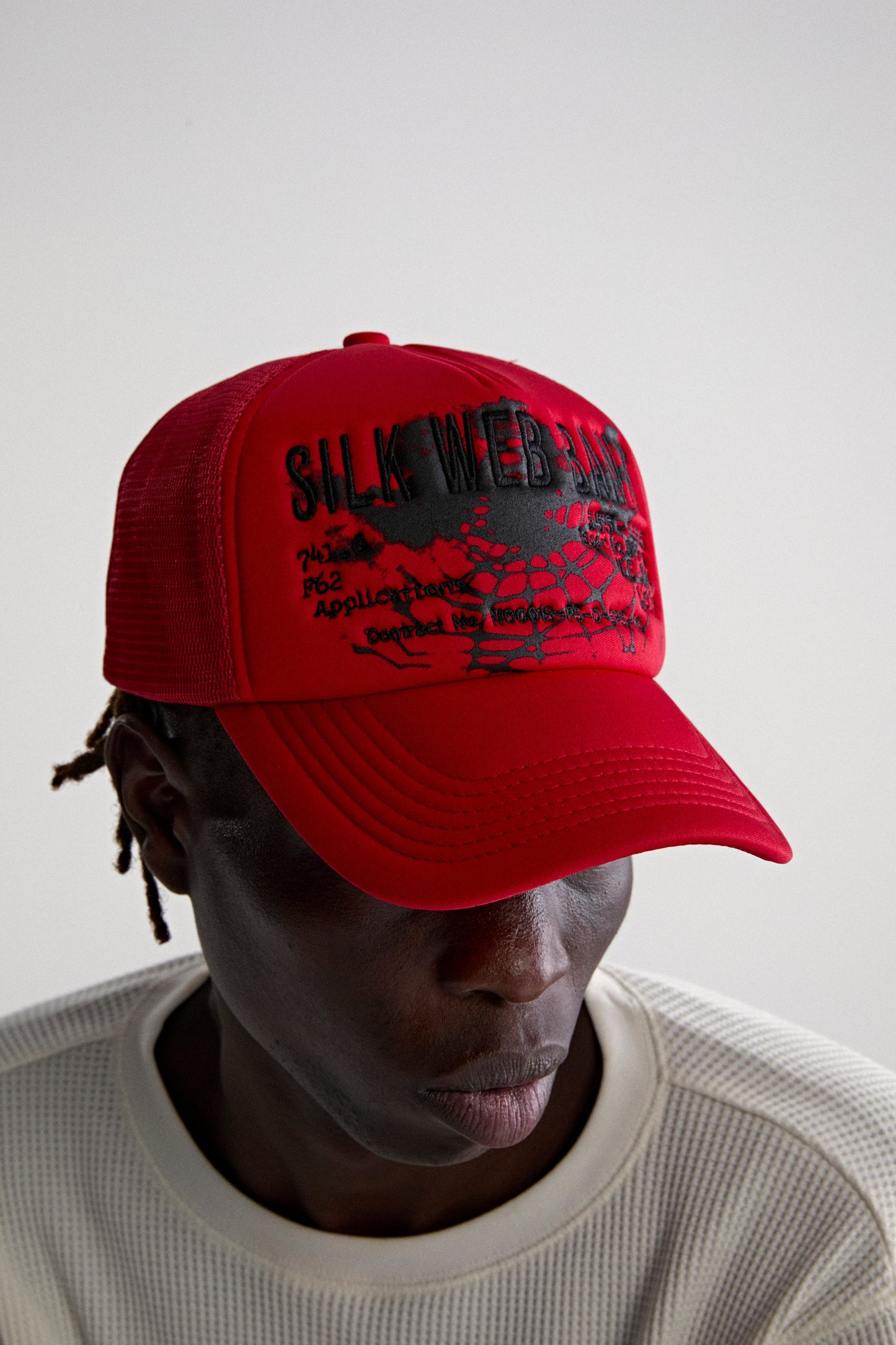 RED SILK WEB BANK TRUCKER ON MODEL