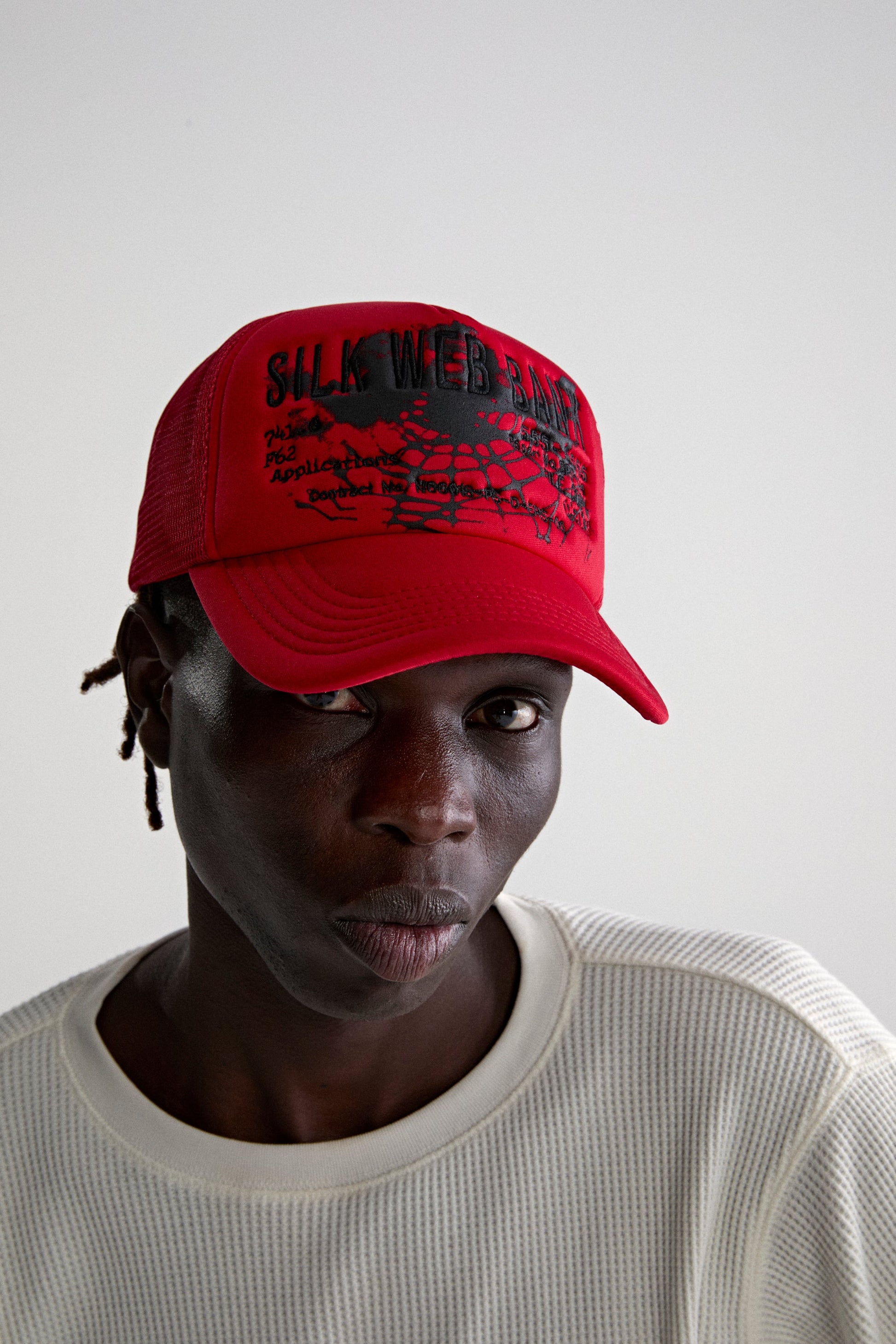 RED SILK WEB BANK TRUCKER ON MODEL