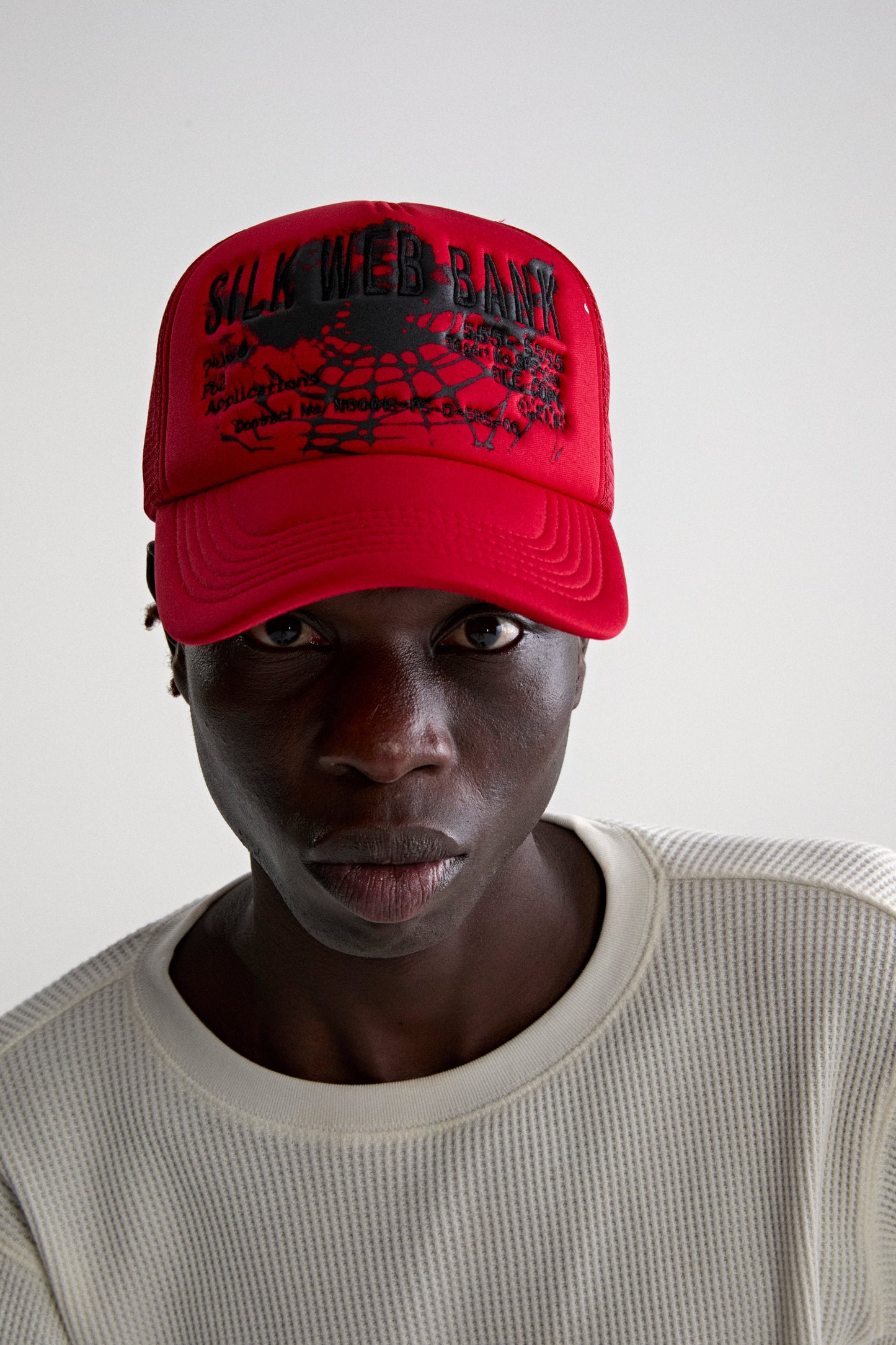 RED SILK WEB BANK TRUCKER ON MODEL