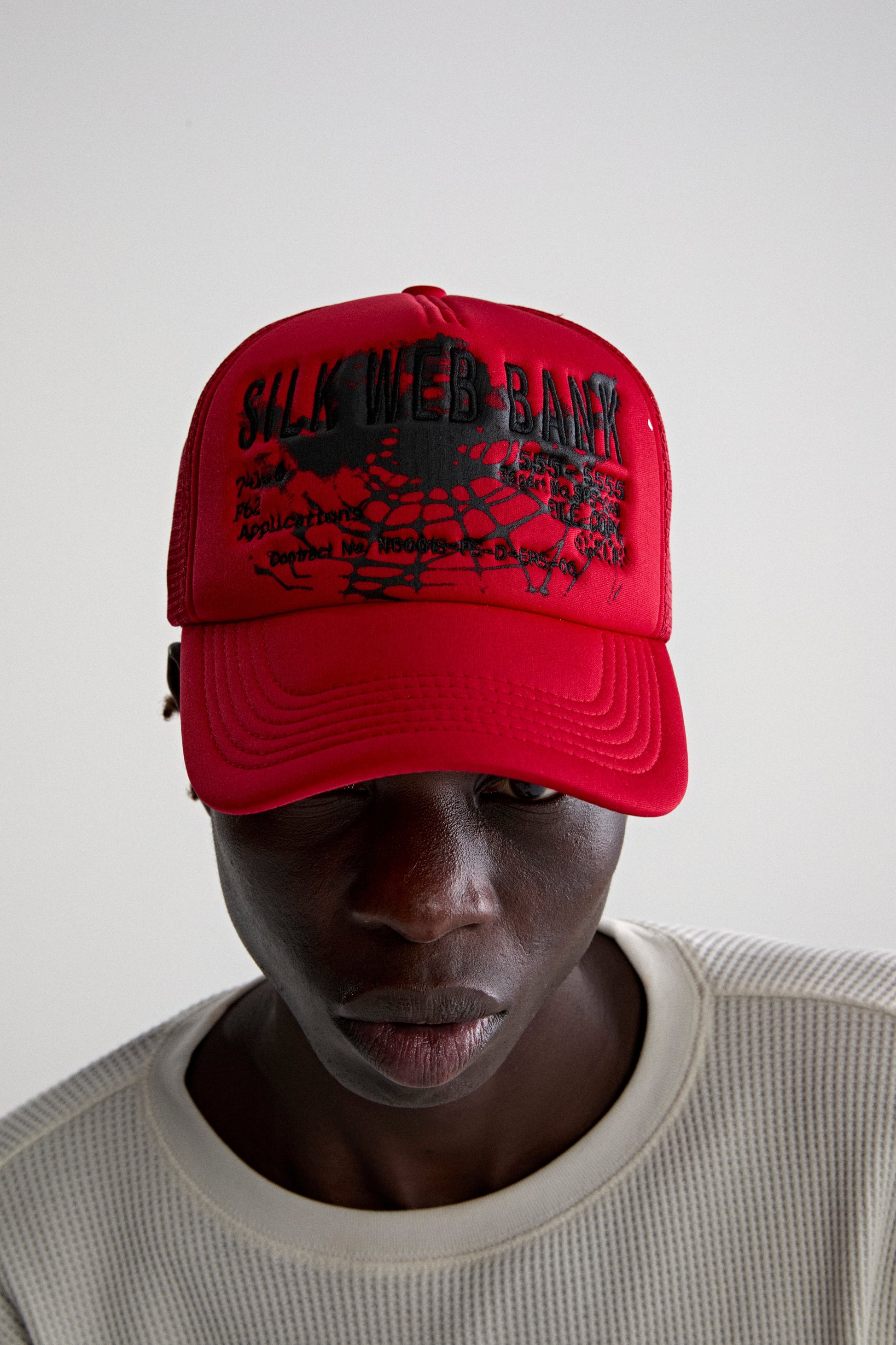 RED SILK WEB BANK TRUCKER ON MODEL