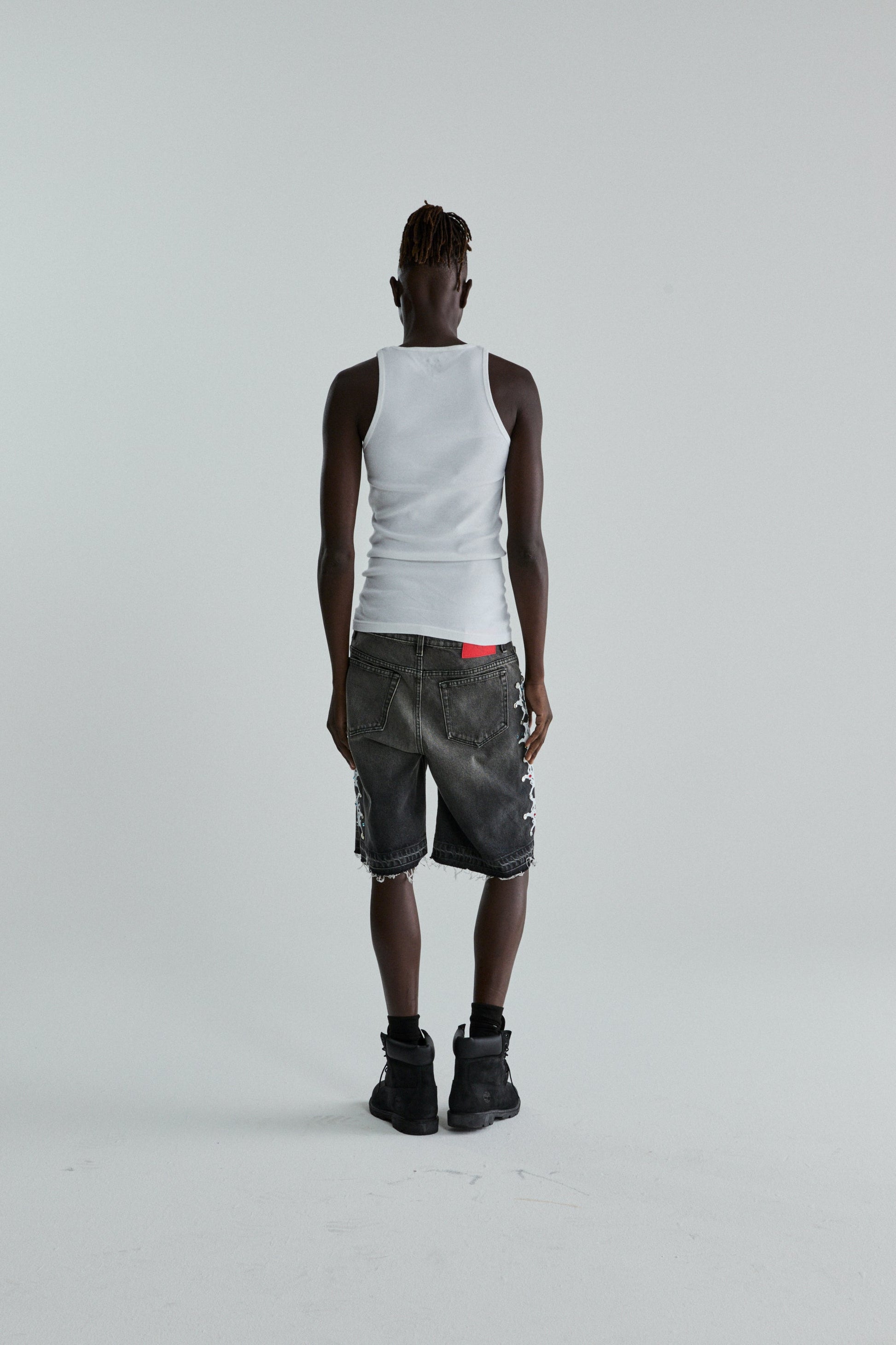 BLACK WASH WEB STONE DENIM SHORTS ON MODEL