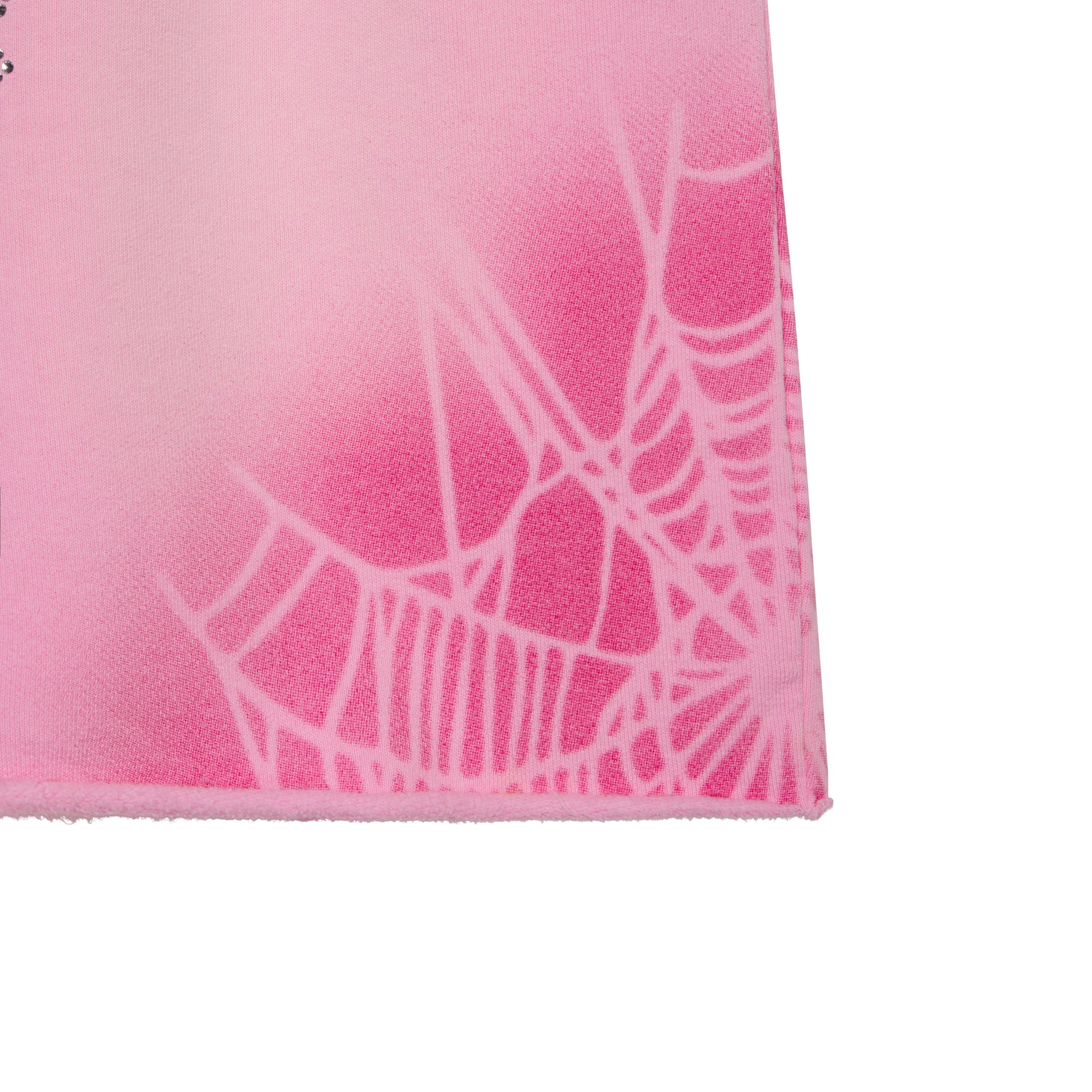 Pink cotton fleece sweatshort with spray web graphic design and raw hem.