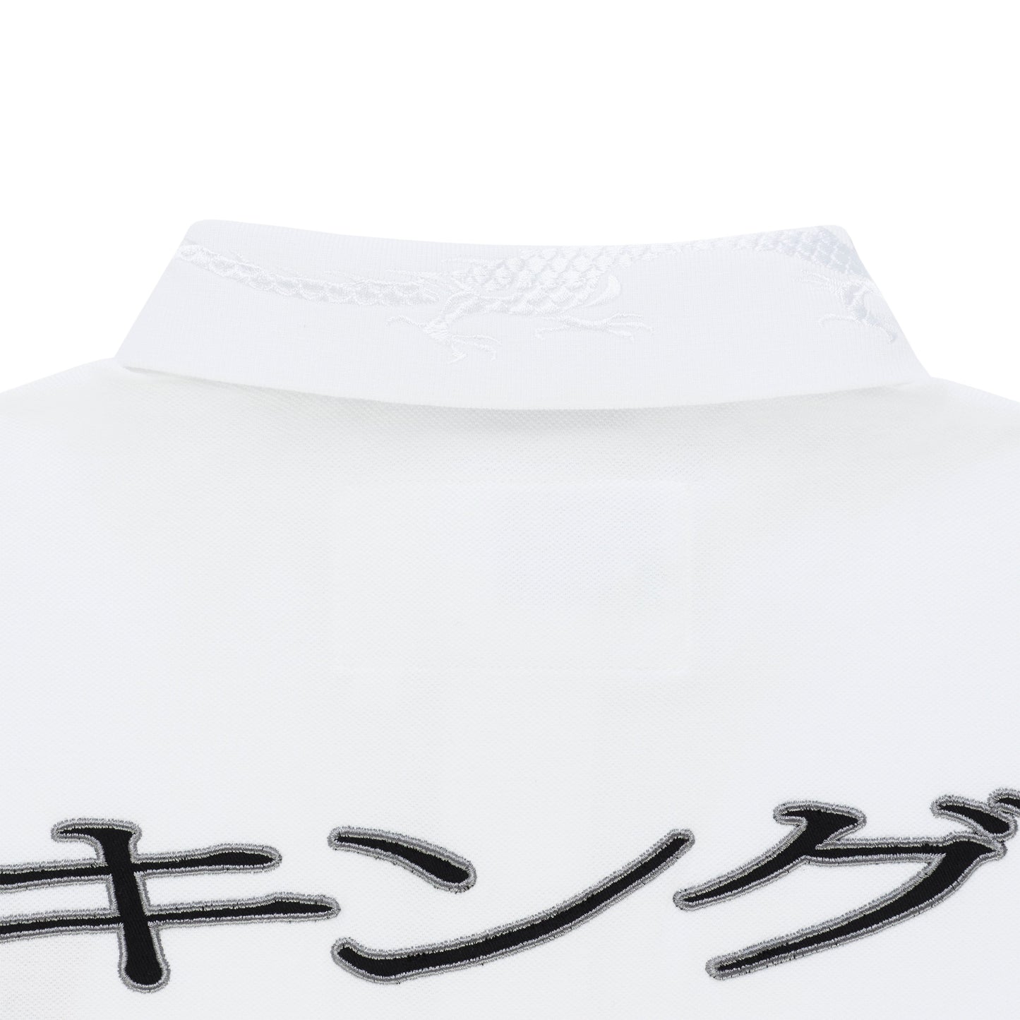 White polo shirt with embroidered dragon on collar and black Japanese characters.