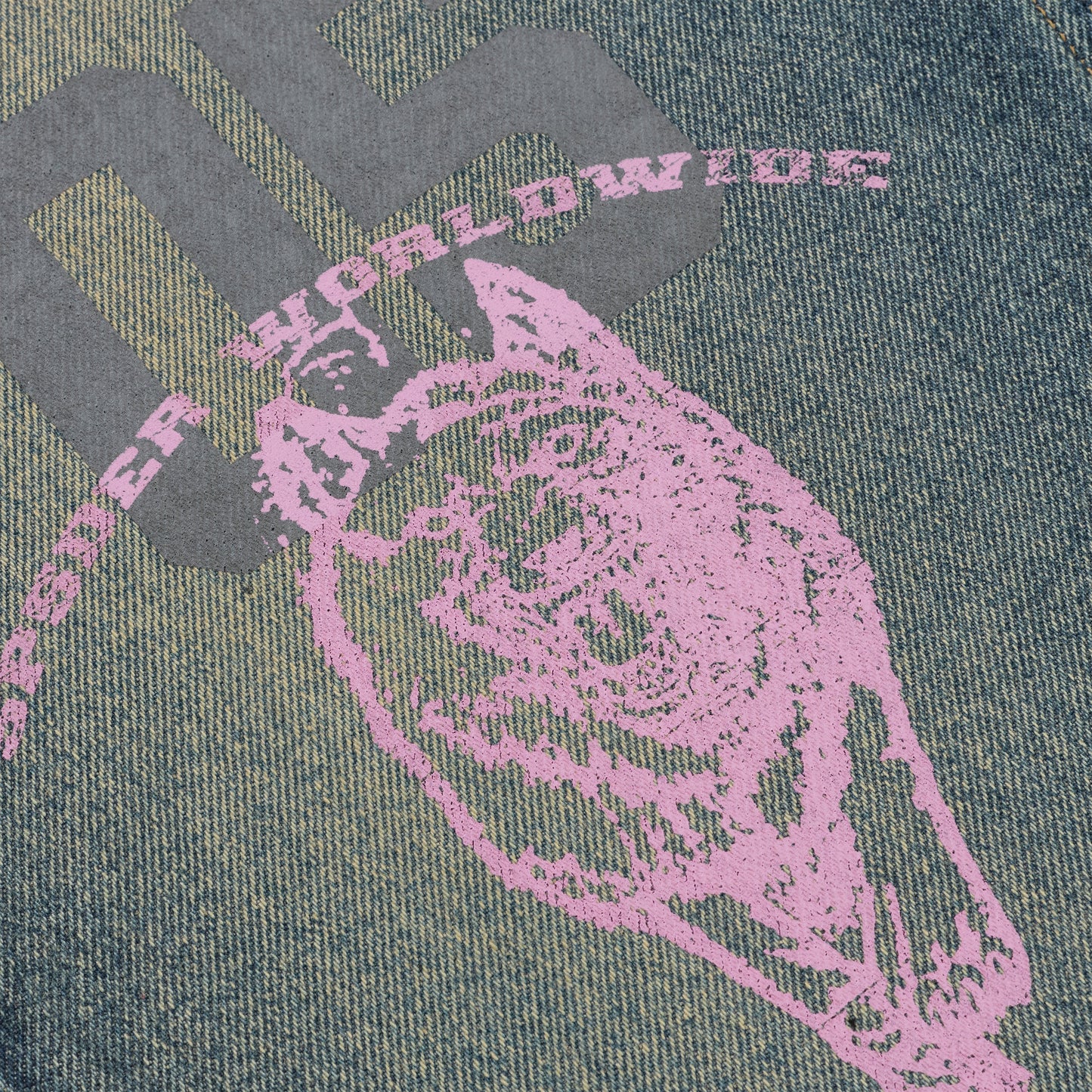 Washed blue denim jeans with a large pink graphic print and gray "WORLDWIDE" text.