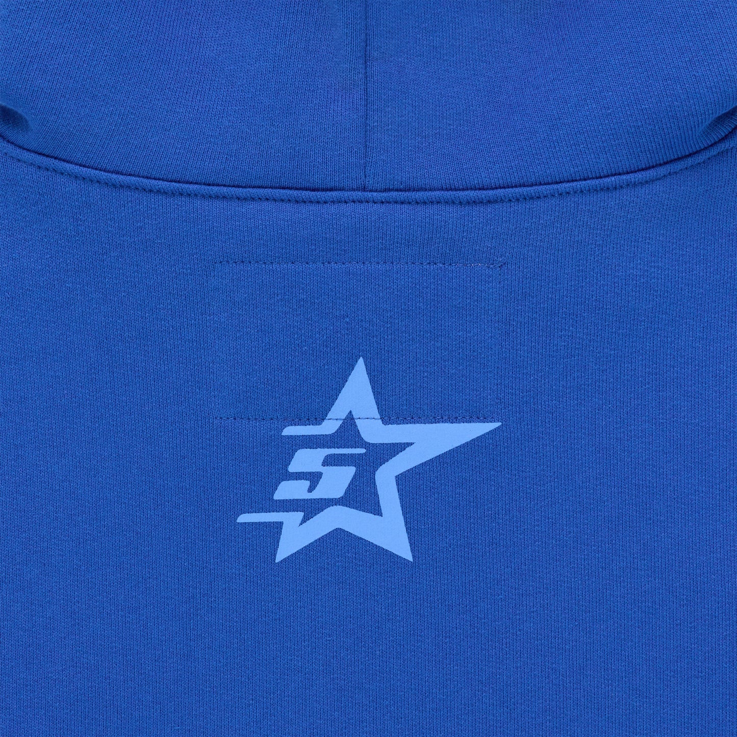 Close-up of a blue hoodie with a light blue star and "SG" logo on the back.