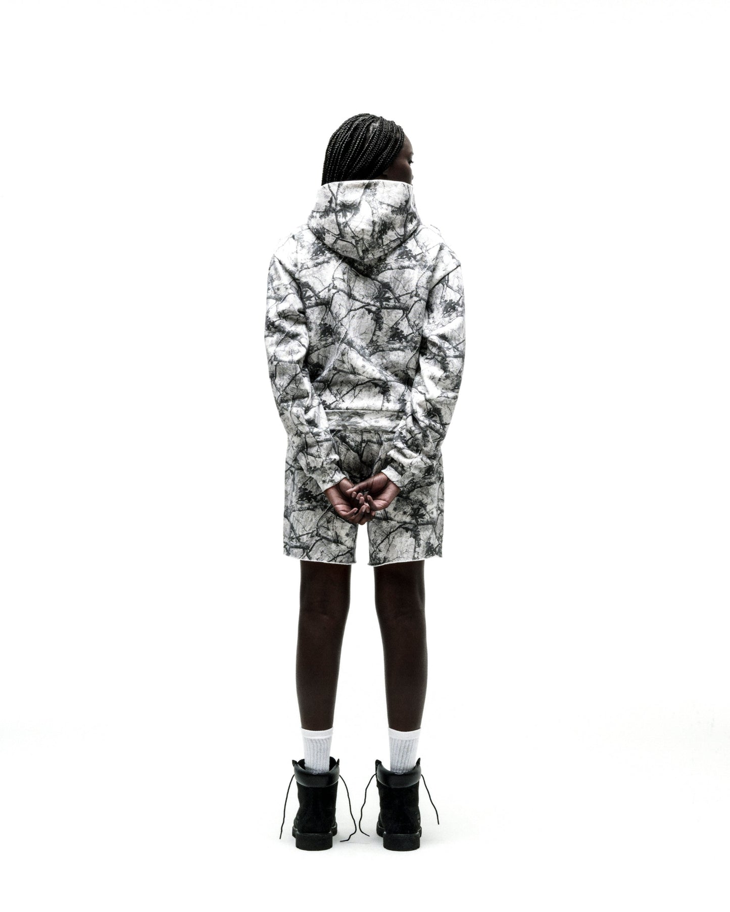 Person from behind wearing a white Realtree OG Web V2 zip hoodie and matching shorts.
