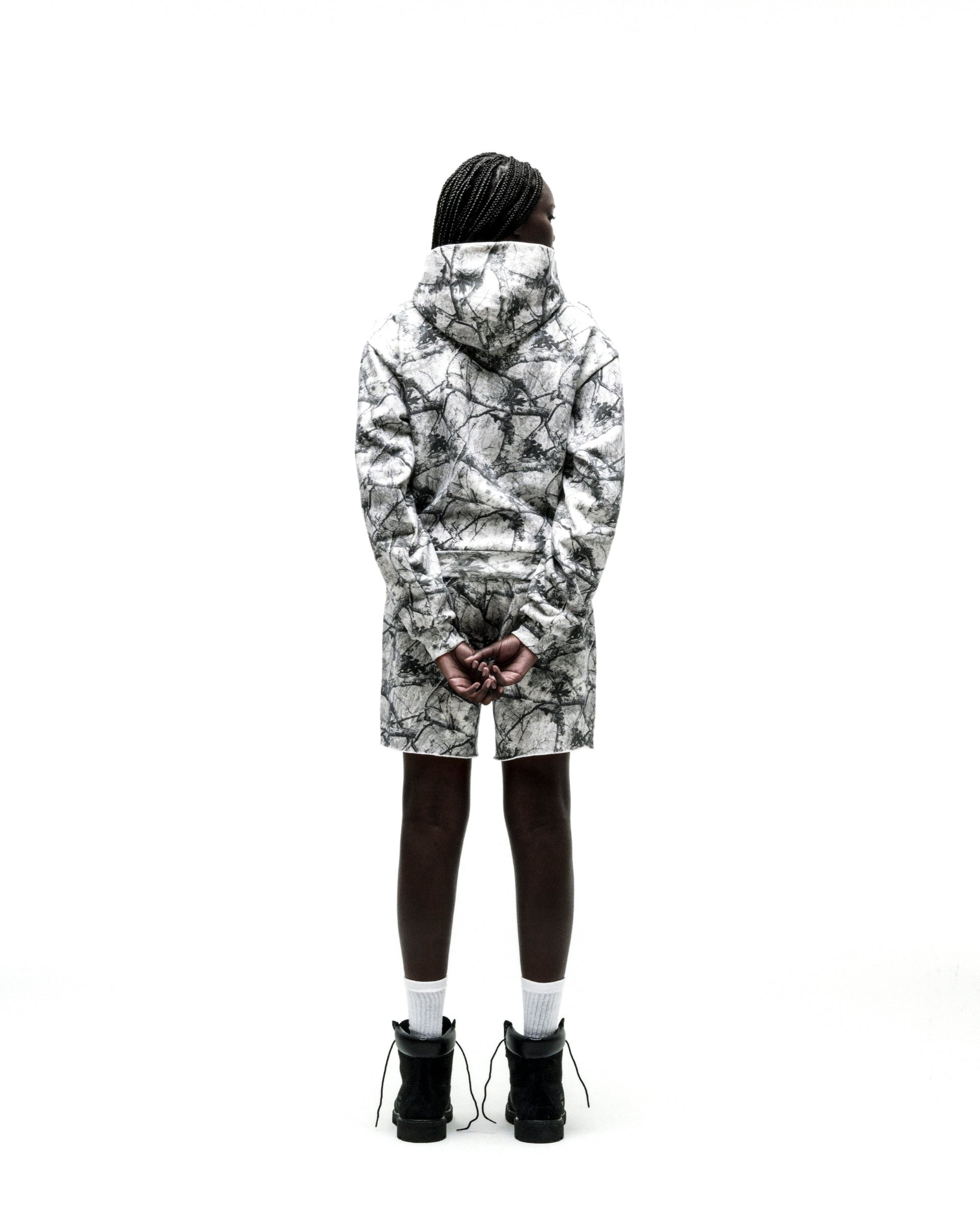 Person from behind wearing a white Realtree OG Web V2 zip hoodie and matching shorts.