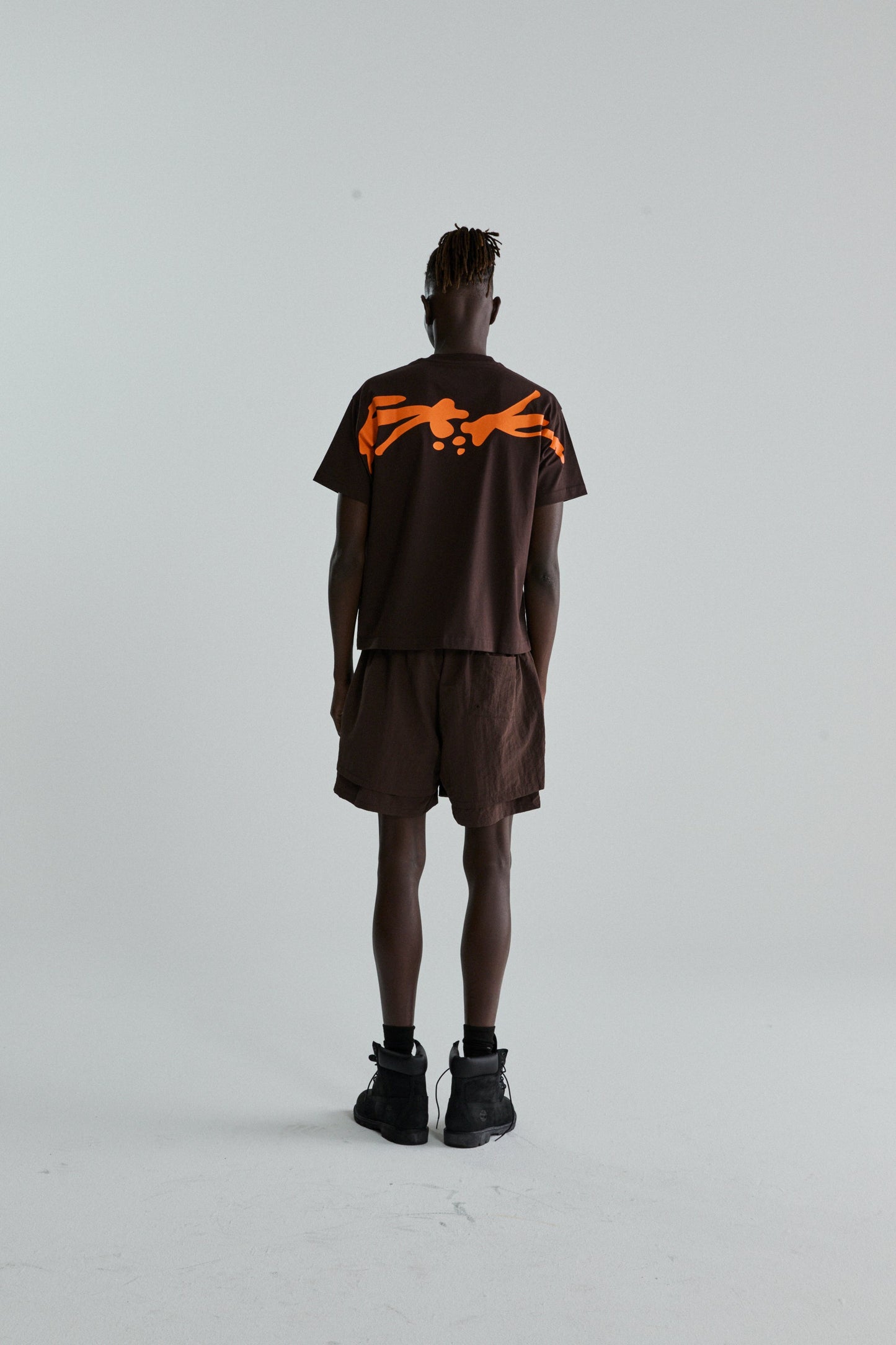 BROWN TM TEE ON MODEL