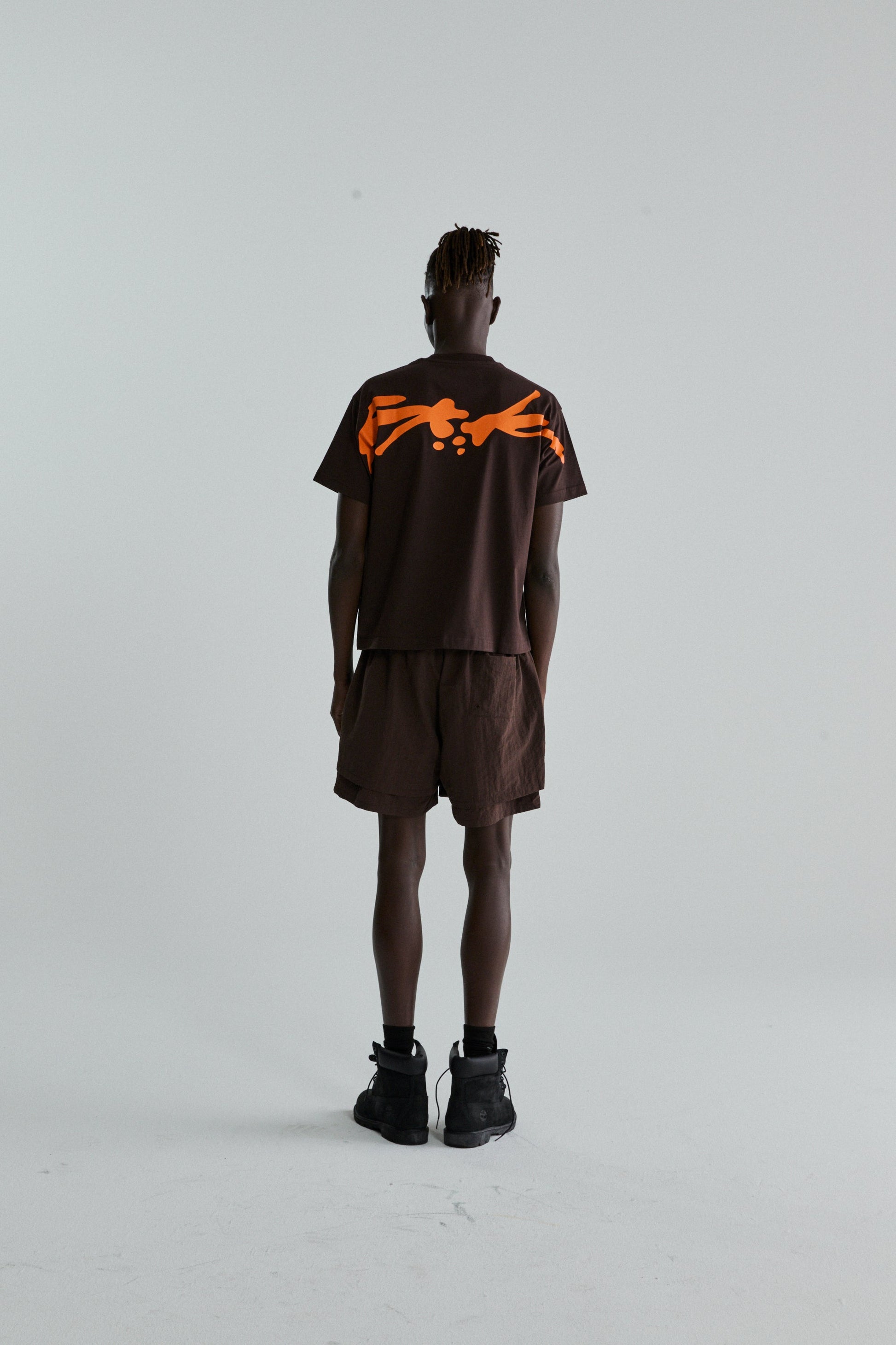 BROWN TM TEE ON MODEL