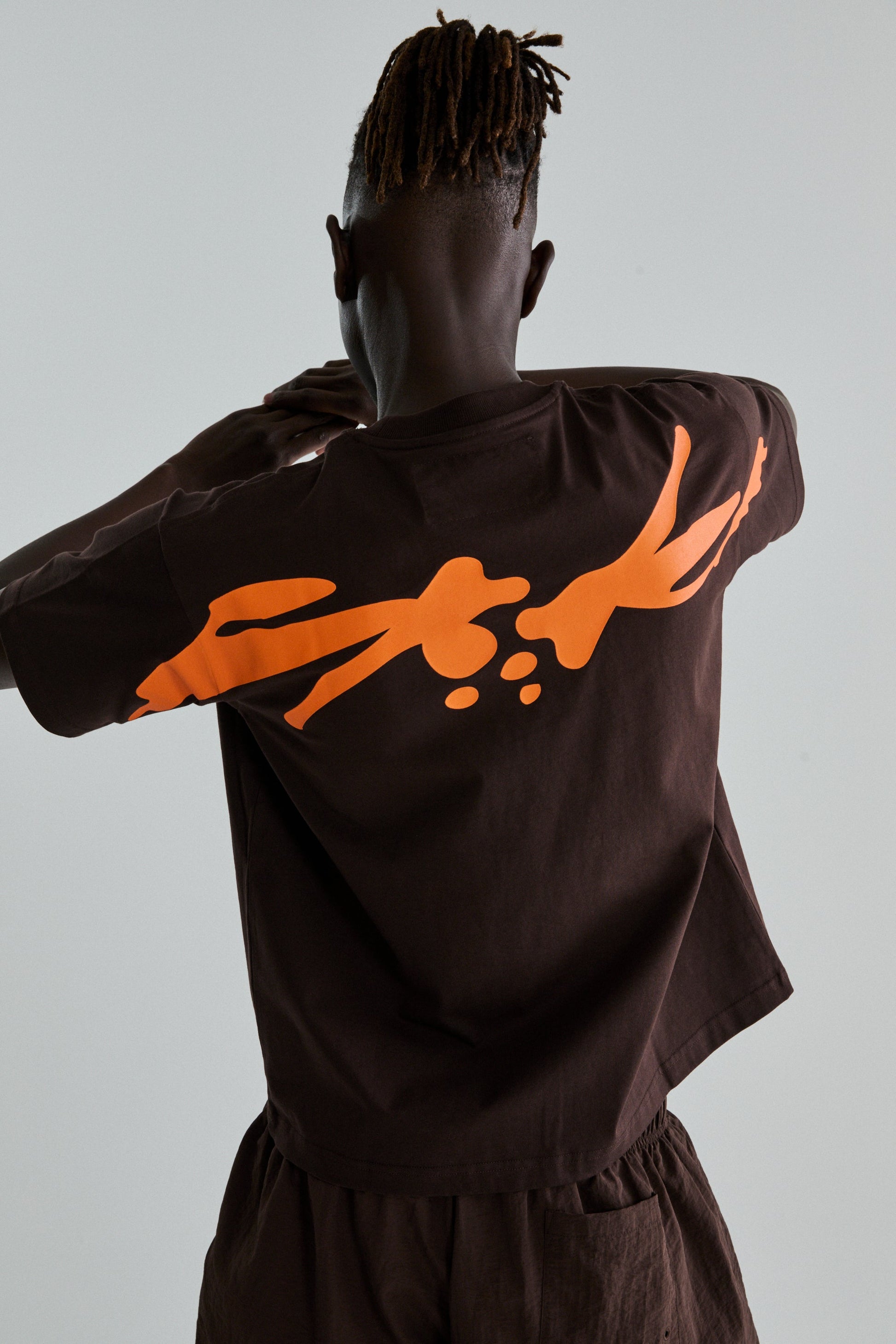 BROWN TM TEE ON MODEL