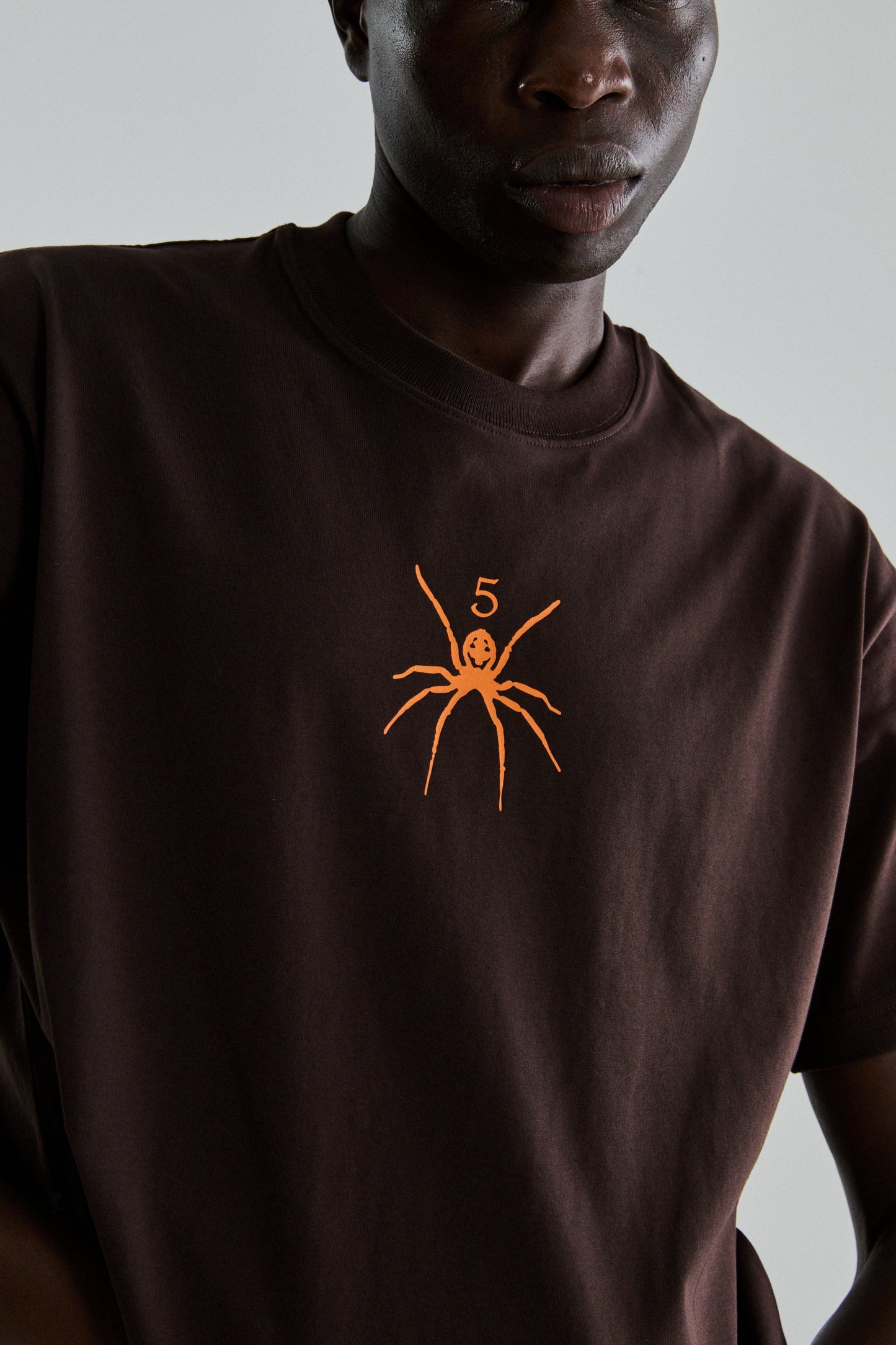 BROWN TM TEE ON MODEL