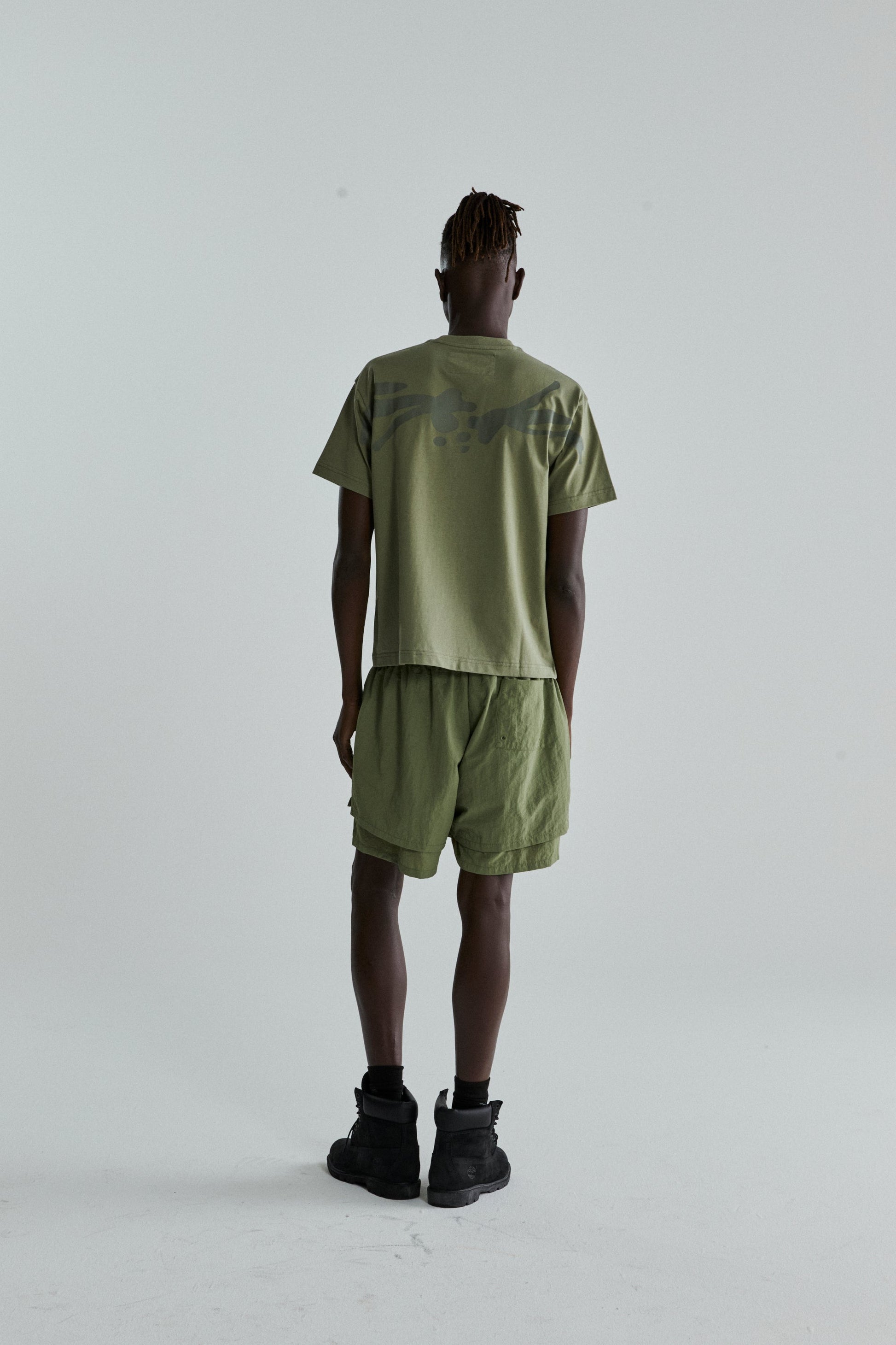 SAGE GREEN TM TEE ON MODEL