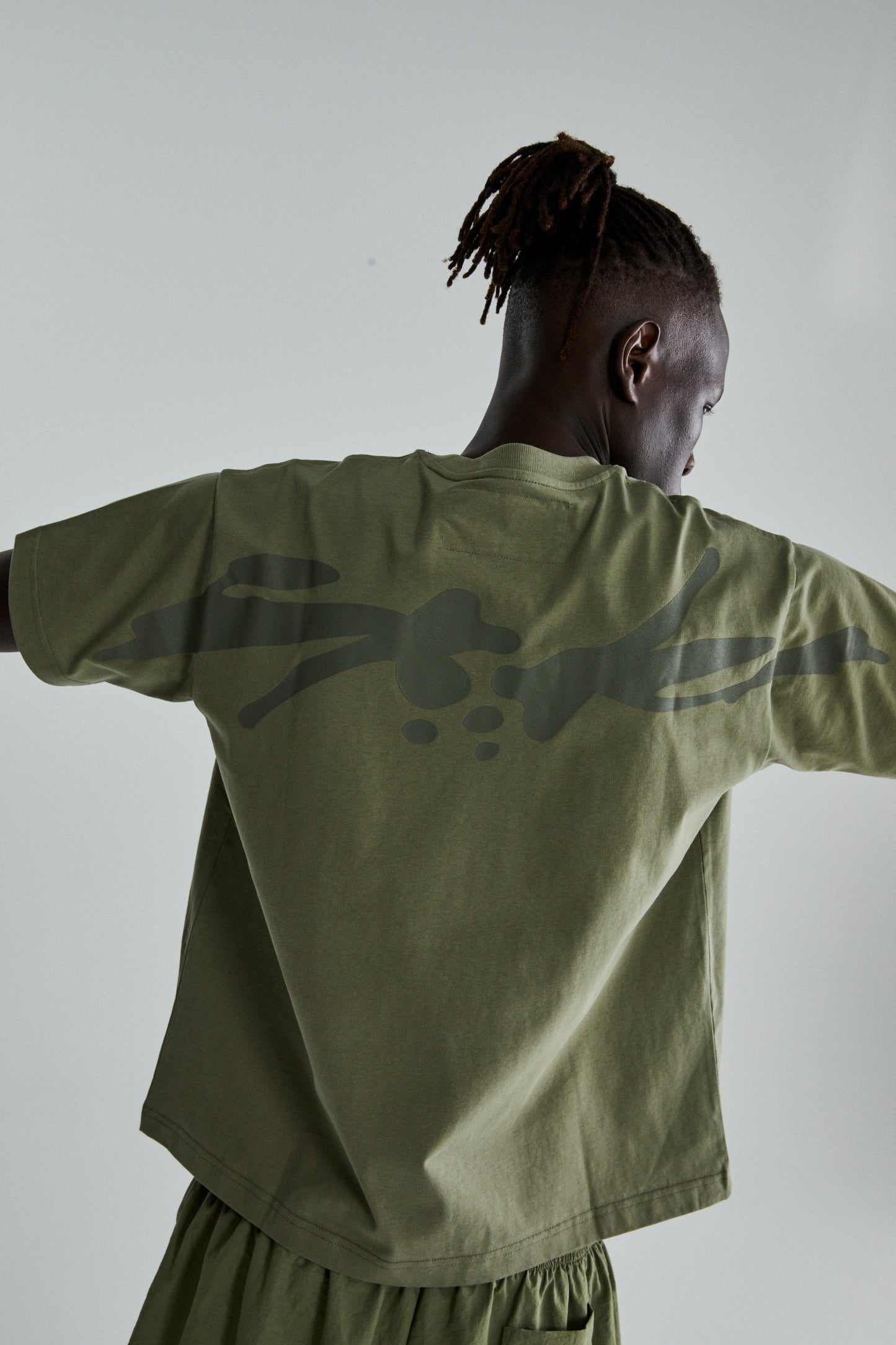 SAGE GREEN TM TEE ON MODEL