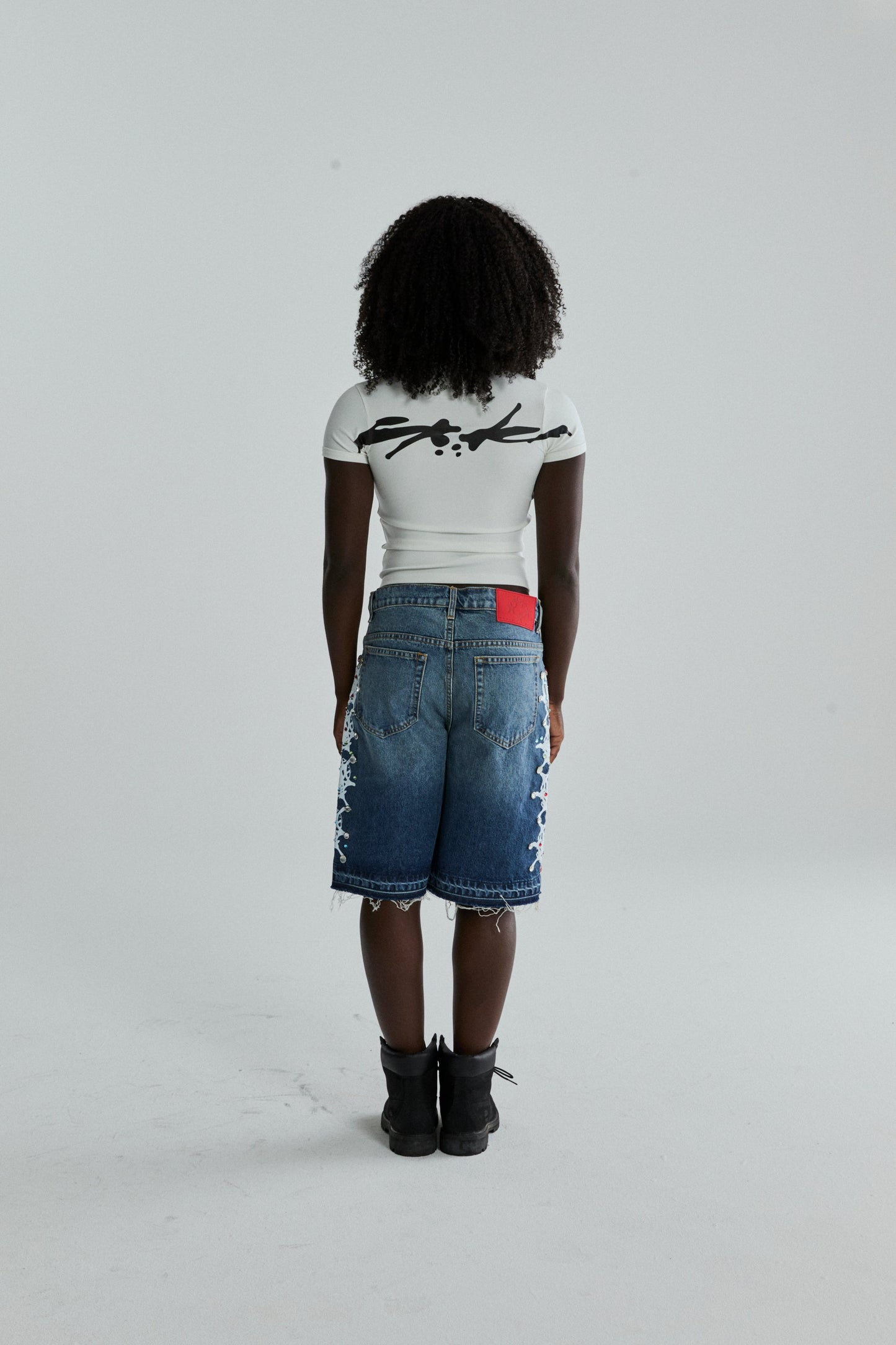 WHITE TM BABY TEE ON MODEL
