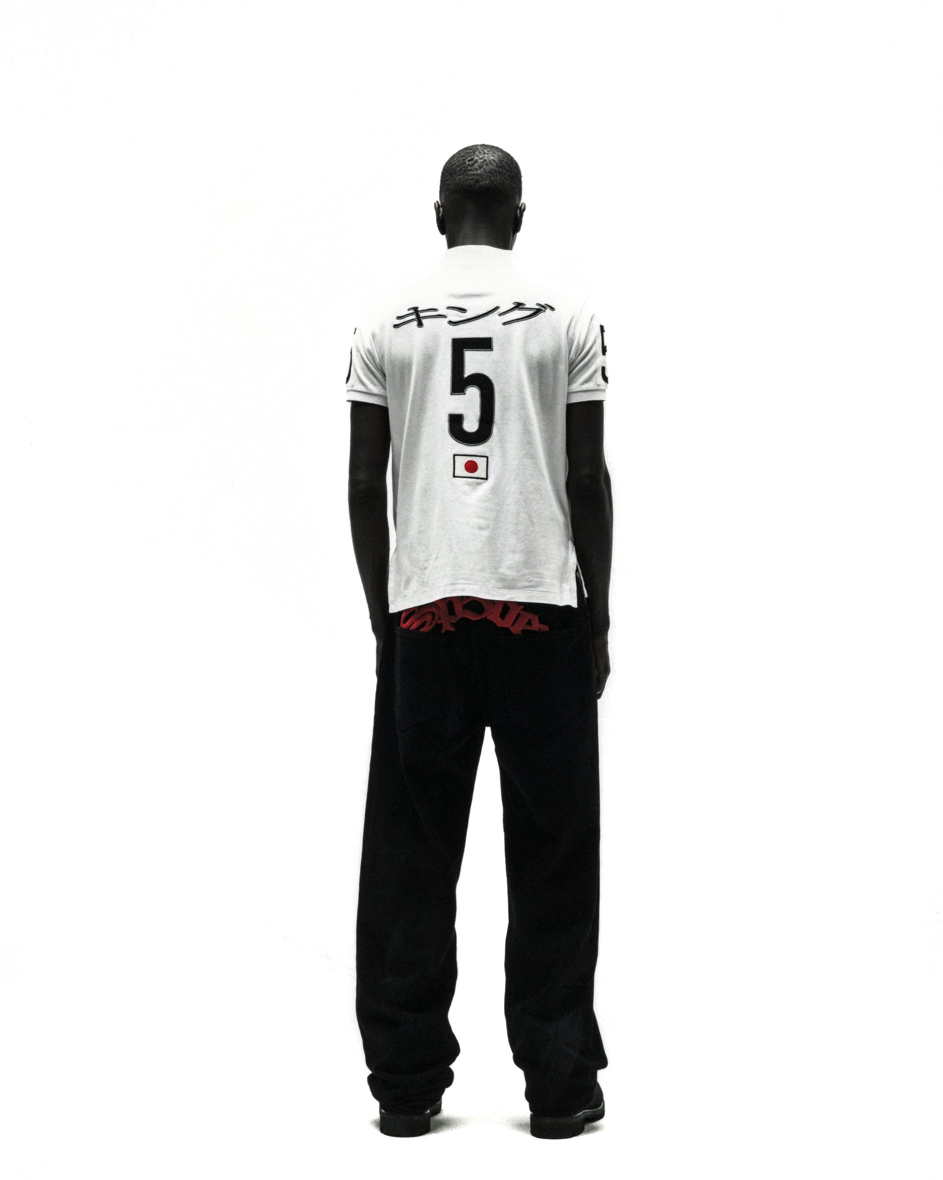 White polo shirt with Japanese text, large black "5", and a Japanese flag emblem on the back.