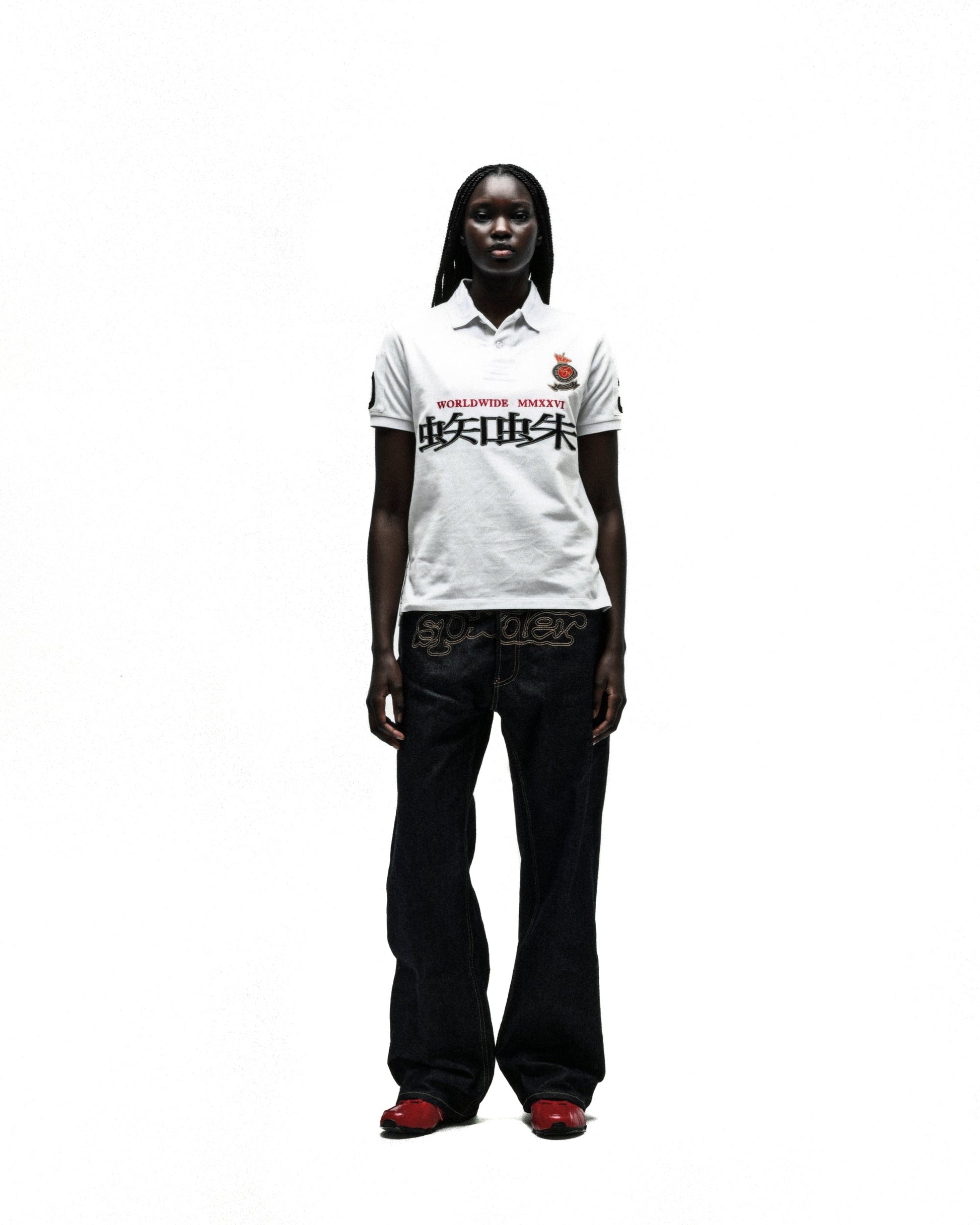 White cotton polo shirt with "WORLDWIDE MMXVI" and red Chinese characters, worn by a model.