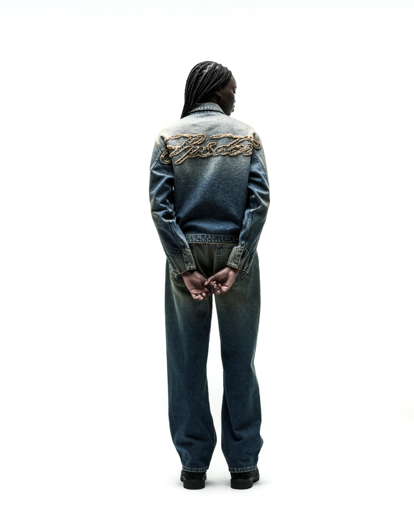 Washed blue denim work jacket with "SCRIPT" embroidery on back, paired with matching jeans.