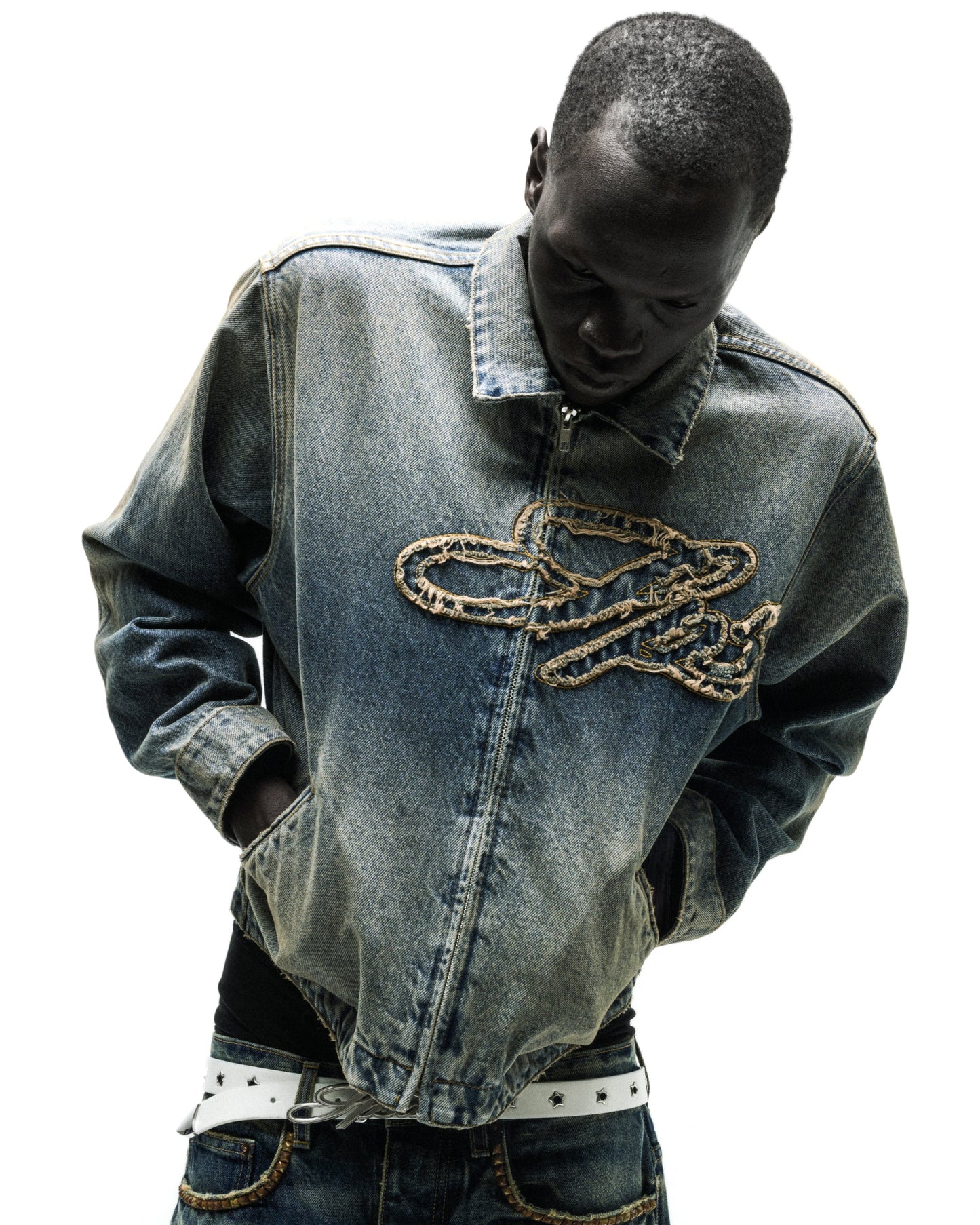 Washed blue denim work jacket with a unique script logo design on the chest.