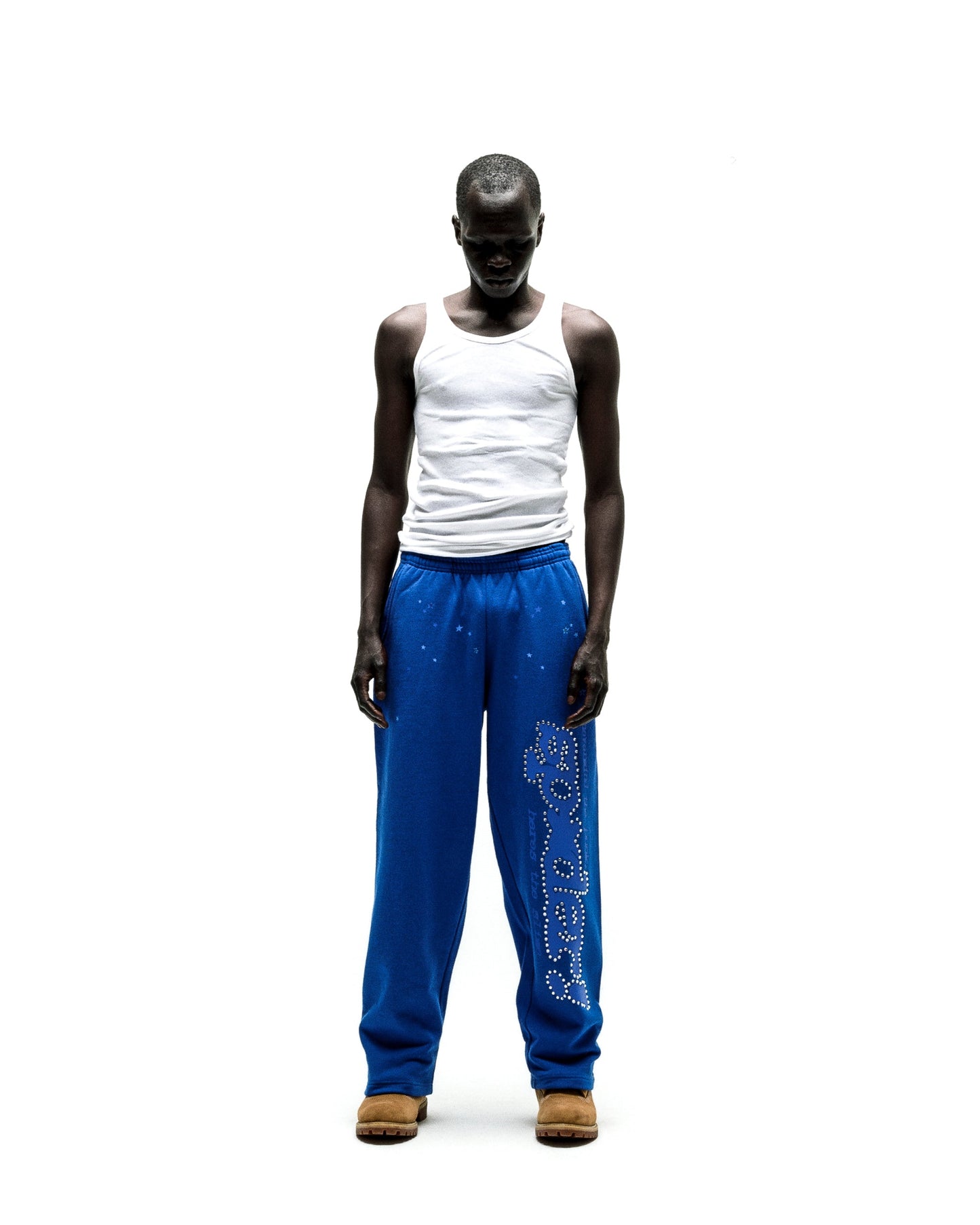 Blue cotton fleece sweatpants with "P*NK SP5DER" text and scattered stars in rhinestones.