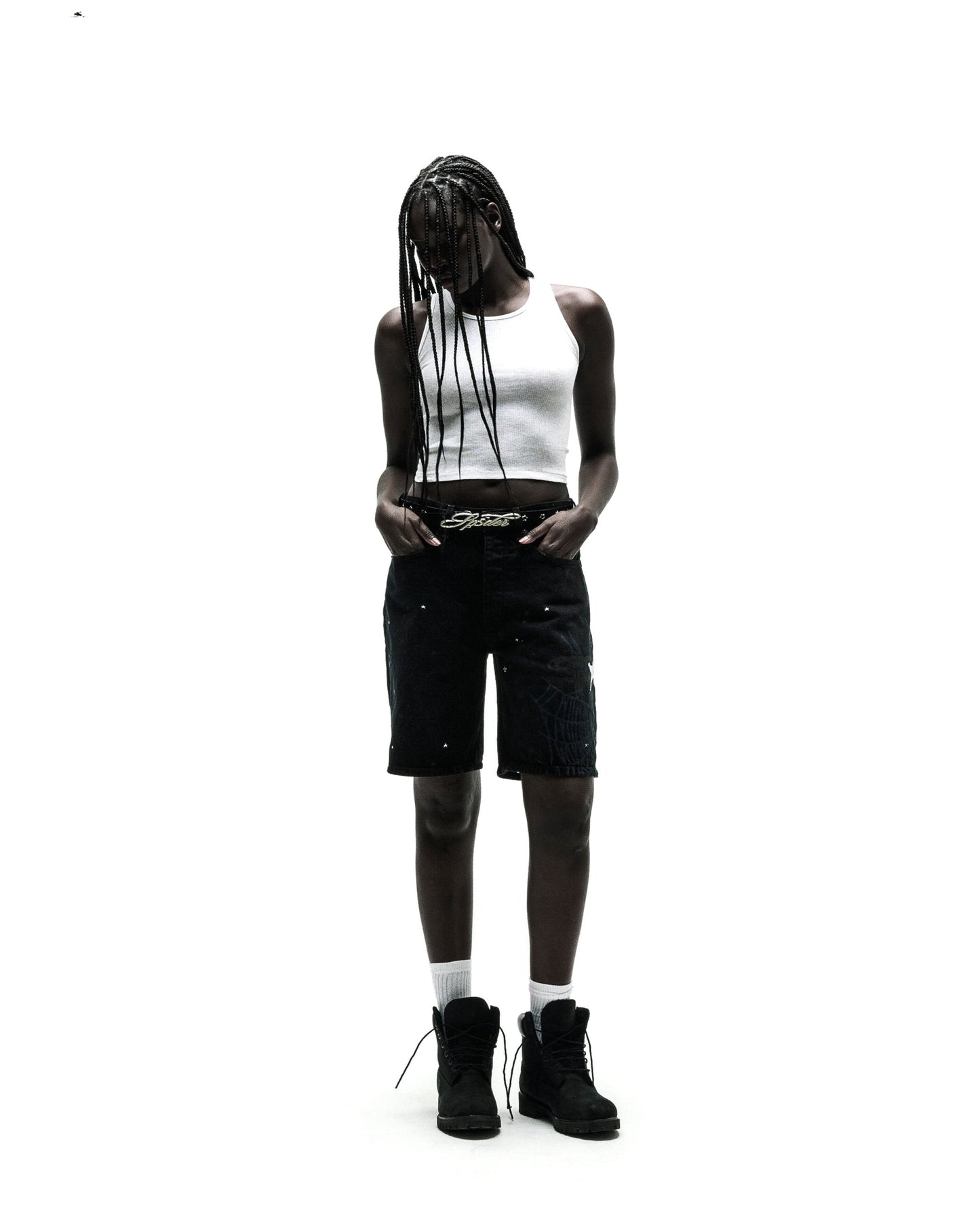 Black HEAVY WEB JEAN SHORTS with white spiderweb graphic, worn by a model with a white tank top and black boots.
