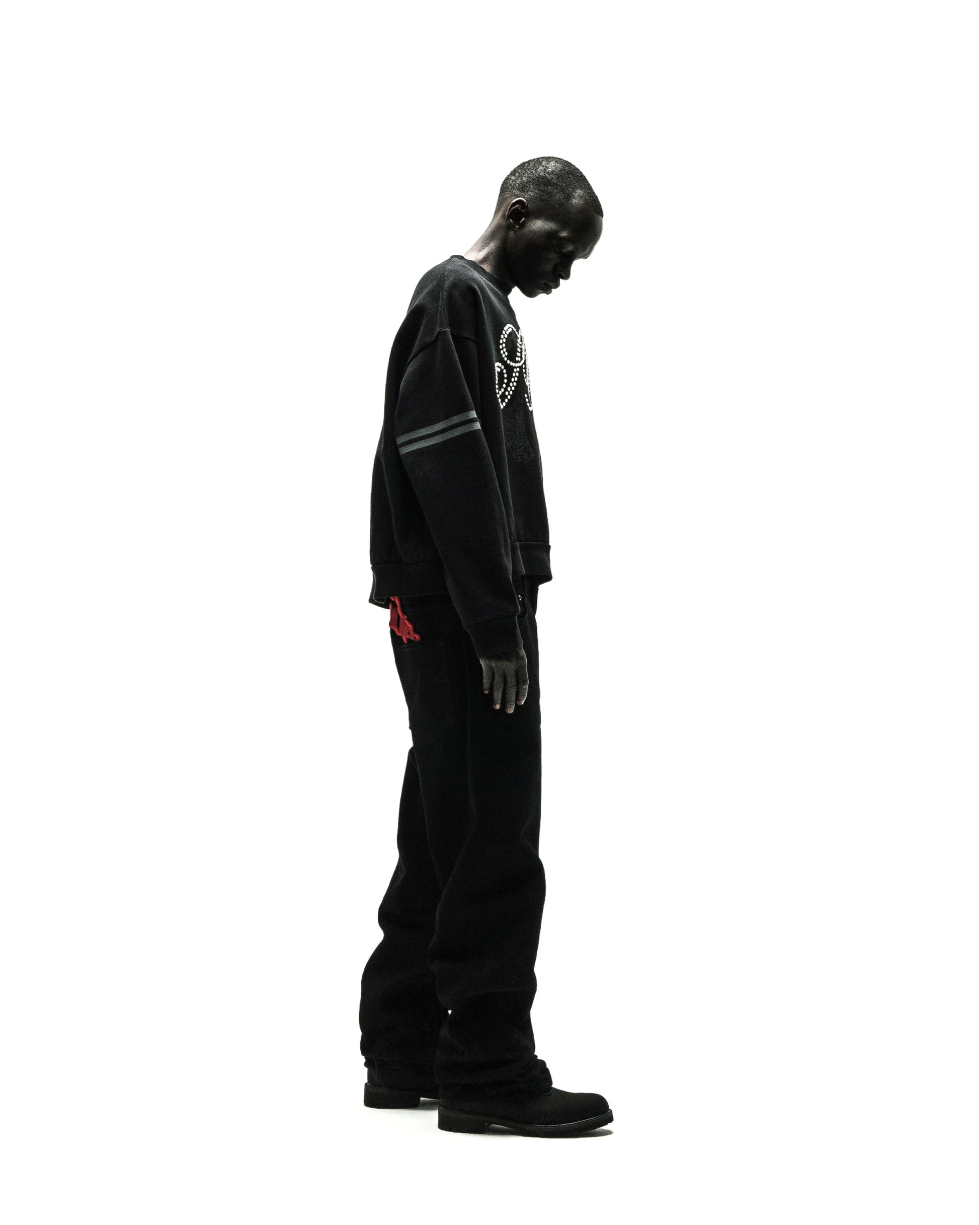 ARANEA CREWNECK: Black oversized sweatshirt with white graphic, grey arm stripes, and black pants.